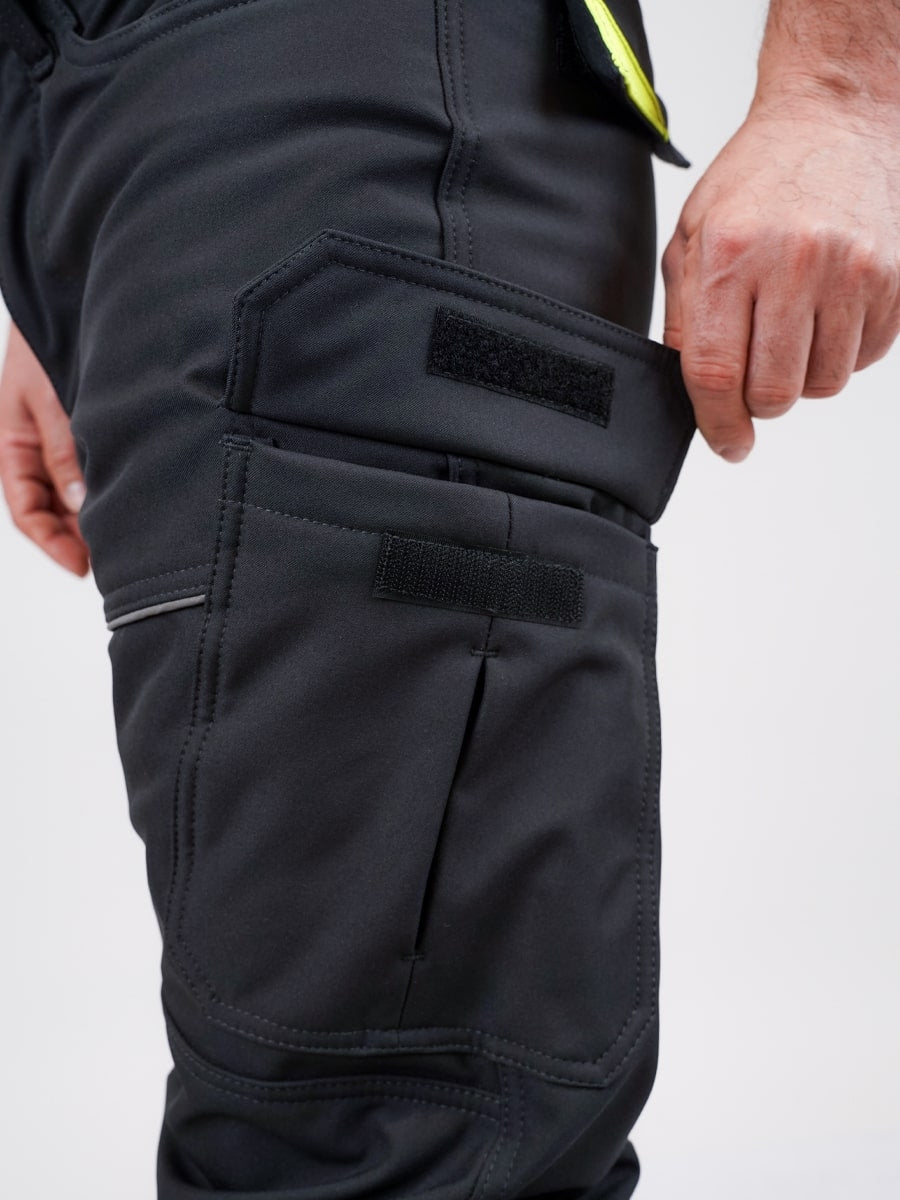 Dunkle Softshell-Bundhose mit seitlicher Tasche und verstärktem Kniebereich, gelbe Naht