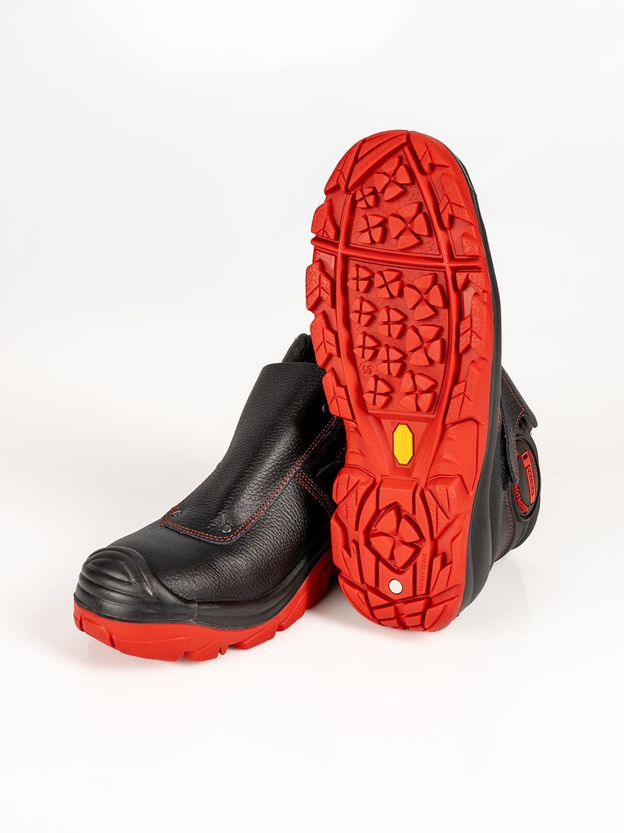 Schweißer-Sicherheitsstiefel mit sichtbarer Laufsohle, rotes Profil und schwarzes Leder.